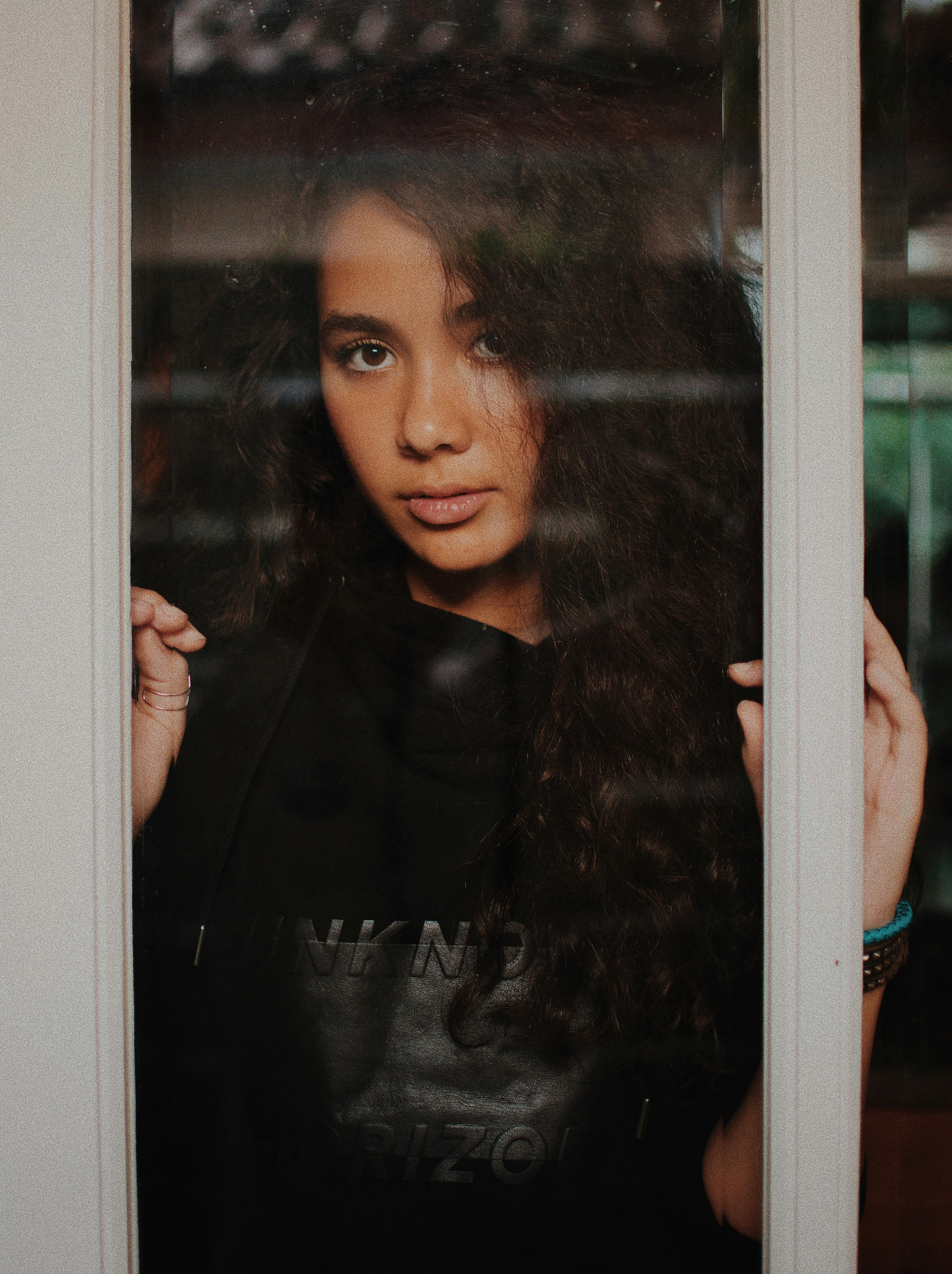 woman holding windowpane